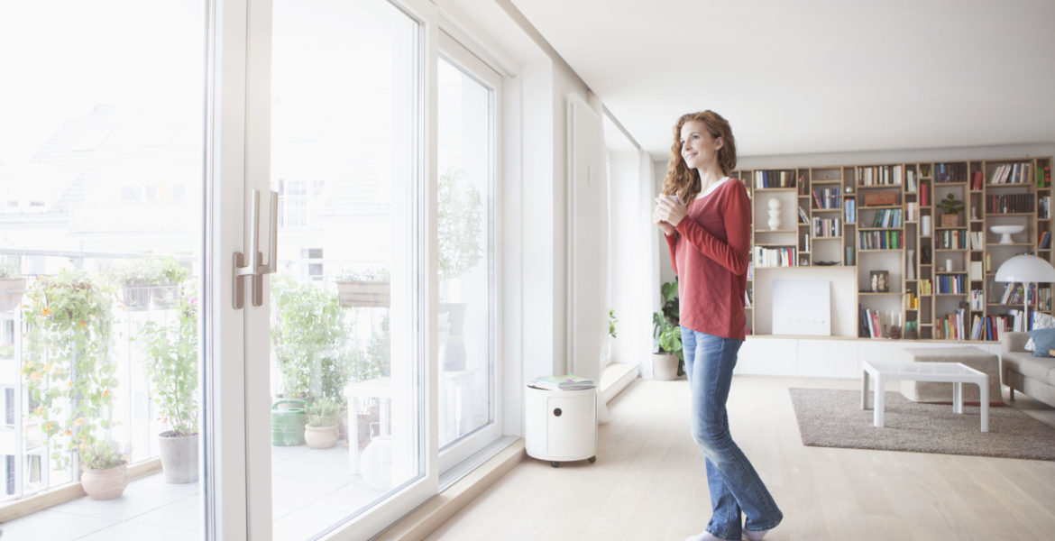 Woman at home looking out of window