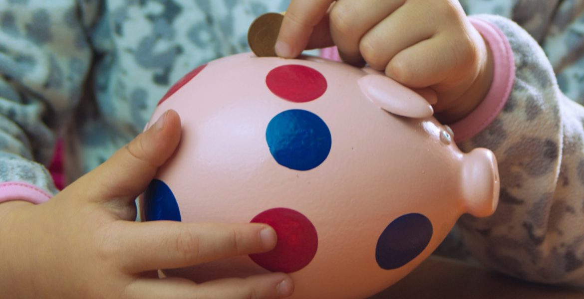 little girl holding piggy Bank, family budget,